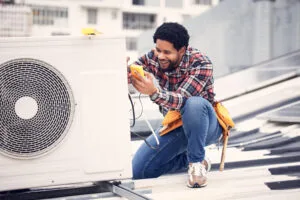 Technician performing heat pump repair in Parsippany, NJ.